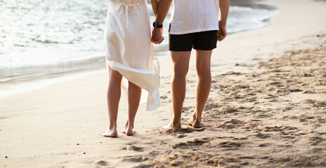 couple walking on sandy beach