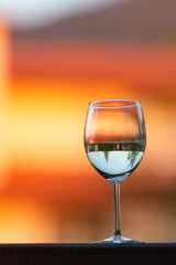 white wine glass on the sunset blur background
