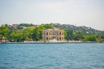 Fototapeta na wymiar Beautiful palace hotel and sea water over the Golden Horn bay in Istanbul, Turkey