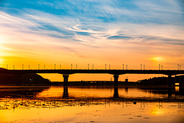 Fototapeta premium Beautiful Ukrainian sky with bridge on background. Blue and yellow color heaven.