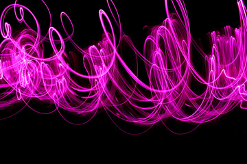 Long exposure light painting photograph of neon colour fairy lights in an abstract swirl pattern...