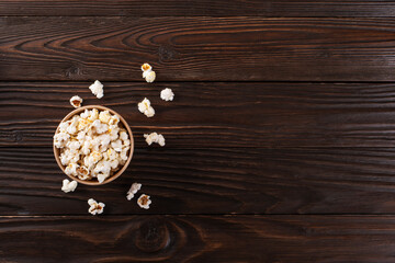 Popped corn snack in paper bucket on kitchen table flat view