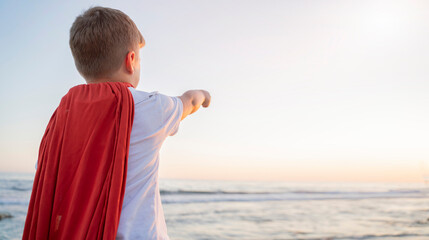 child boy in a superhero costume with a red cape