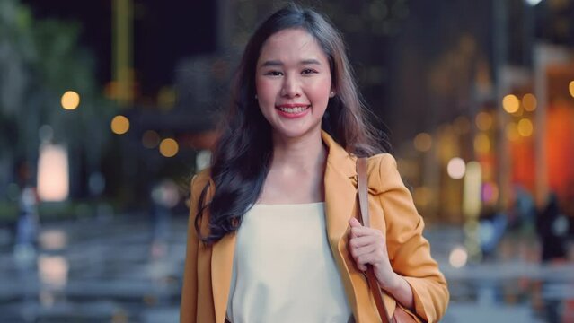 Urban modern lifestyle fashion portrait of asian young female stylish casual Asia woman walking 
 with confident look at camera on the urban downtown street, wearing cute trendy outfit after raining