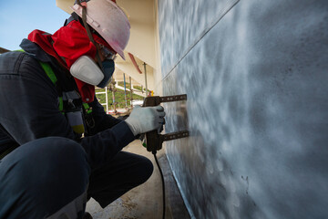 A male worker at high test steel tank butt weld  carbon shell plate of storage tank crude oil