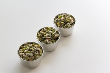 three cups of Origanum dictamnus, dittany of Crete tea on a white background. Cretan dittany or hop marjoram is a medicinal tea growing wild only in Crete. It is a healing, therapeutic and aromatic
