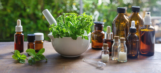 Herbal medicine, alternative heal. Nature pharmacy and homeopathy. Fresh herb in a mortar on table