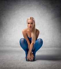 Beautiful blonde girl with perfect legs in blue pantyhose - beauty glamour portrait.