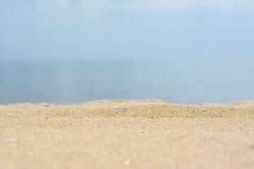 Beautiful beach with golden sand near sea, closeup view.