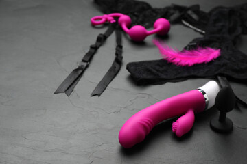 Sex toys and lingerie on black background. Space for text