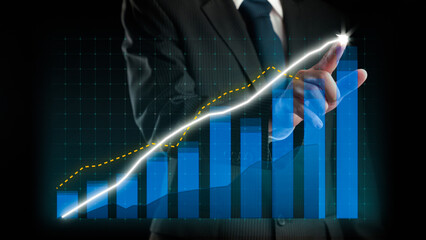 Businessman draw finance allusive graph chart showing business profit growth increasing to future target . Excellent financial status of corporate business rise up . Finance and money technology .