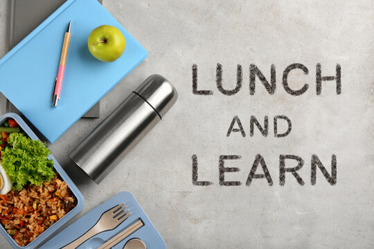 Lunch and Learn concept. Flat lay composition with thermos, food and stationery on light grey table