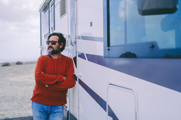 Man standing outside camper van in travel holiday vacation. Renting rv vehicle and enjoy freedom....