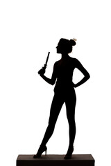 Silhouette of a young slim woman with antique
flintlock pistol in hand