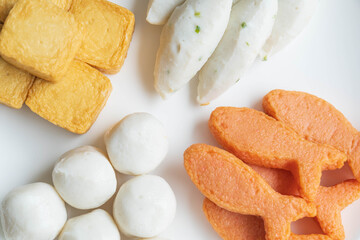 colse up of assorted fish meat ball on white bowl.