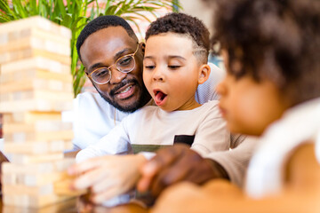 african american mixed race family at the table playing a board game