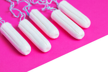 Menstrual period concept. Woman hygiene protection. Cotton tampons on pink background. copy space
