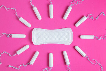 Menstrual tampons and pads on a pink background. Menstruation cycle. Hygiene and protection. copy space