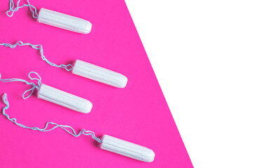 Menstrual period concept. Woman hygiene protection. Cotton tampons on pink background. copy space