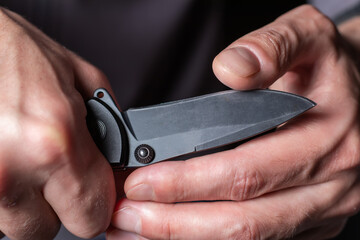 Man holding a knife in a threatening stance ready to fight