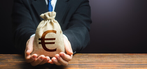 Businessman holds out euro money bag. Mortgage, loan approval. Easy Money. Salary, benefits, profit. Attracting investments. Deposit savings. Cashback. Banking and crediting. Getting a grant. - obrazy, fototapety, plakaty