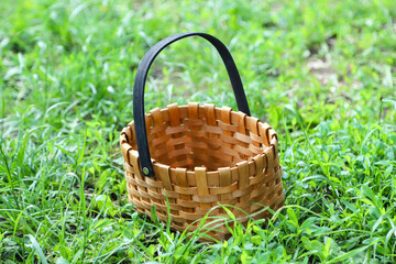 An empty woven basket on the green grass