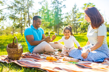 Family with baby on grass in the park authentic emotions