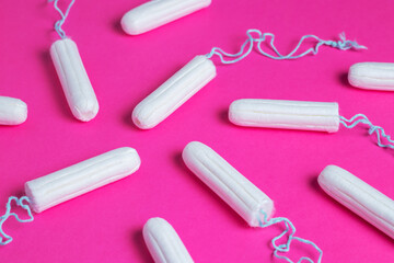 Medical female tampon on a pink background. Hygienic white tampon for women. Menstruation, means of...