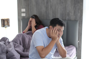 Couple in bedroom. Young couple in bed having problems and crisis.
