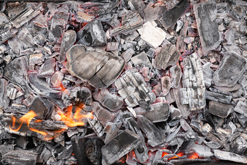 Burning coals texture background close up.