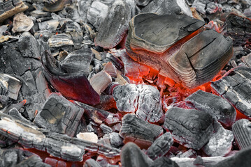 Burning coals texture background close up.