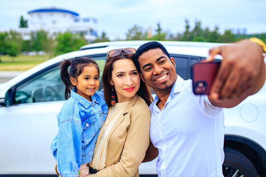 latin hispanic man and beautiful woman with cute daughter taking picture selfie on camera phone
