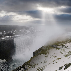 Picturesque full of water big waterfall Dettifoss autumn dull day view with sun rays through clouds, north Iceland.