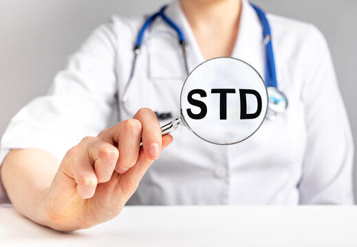 STD acronym, medical disease through magnifier. High quality photo