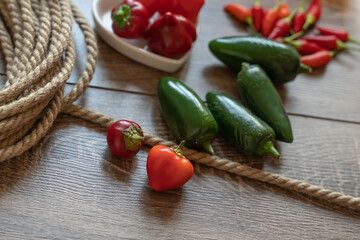 scattering of peppers a pair of red chili on a green jalapeno background selective focus