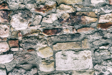 gray stone background uneven and solid pattern, old stone wall