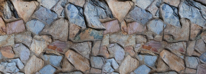 background of gray and brown cobblestones, uneven stones close up