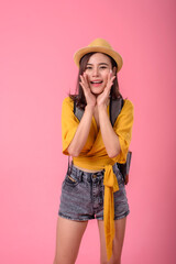 Happy traveler young Asian woman joy relaxing on summer vacation with small backpack on pink background.