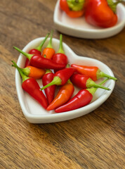 chili red pepper mini pods in a plate heart close up selective focus