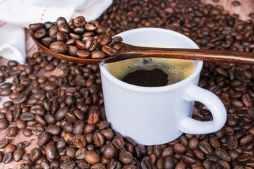 Cup of coffee on coffee beans background.