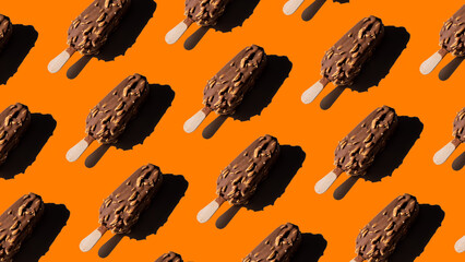 Chocolate ice cream pattern with almonds on orange background. Refreshing summer concept