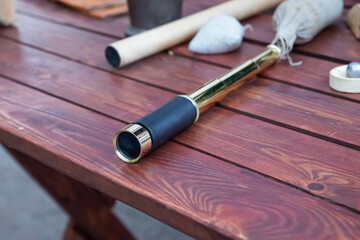 spyglass on wooden table, brass handheld telescope