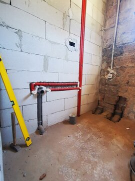 Bathroom Construction At Renovated Home. Installation Of Pipes In Bathroom. Pipe Line Inside Wall