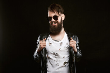 Happy handsome man in sunglasses. Smiling boy with tattoo