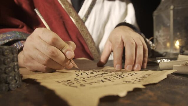 Alphabet in Antiquity.
The Byzantine King writes a letter in old handwriting, accompanied by candlelight.
