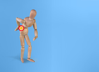 Mannequin back pain. Wood Figure with lower backache. Concept of back pain.