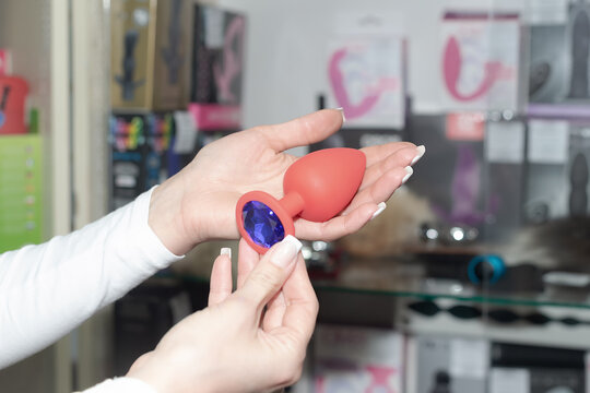 A sex toy in women's hands. Pleasure and satisfaction. Positive emotions