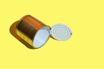 empty metal tin can over yellow background. top view of Mockup or metal tin can design. recycling concept.