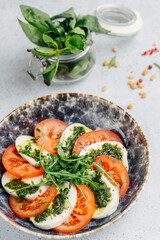 Vegetables cut in circles on a plate sprinkled with greens and green paste