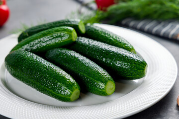 cucumbers are lightly salted on white plate macro close up